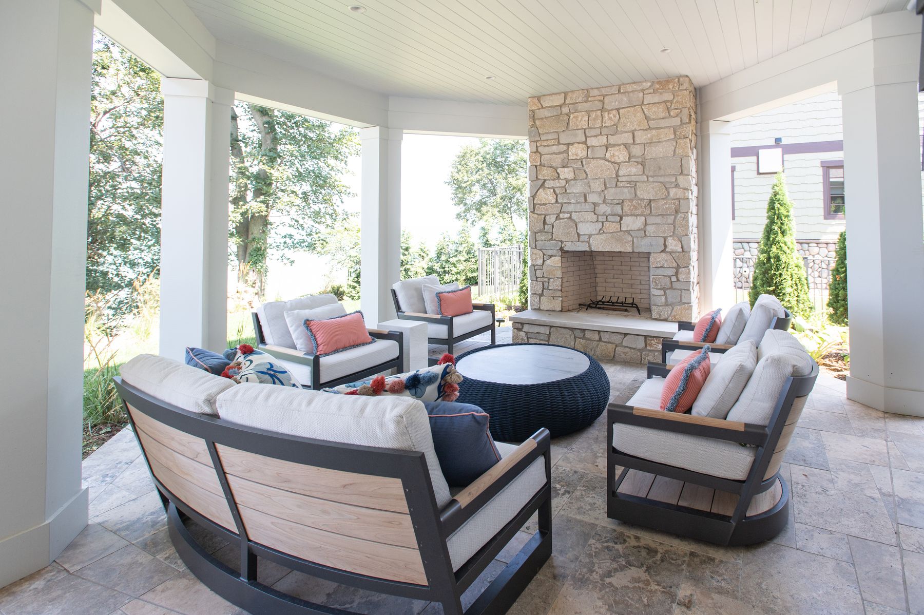 Old Mission Ashlar natural Michigan stone outdoor fireplace on a covered porch by Mike Schaap Builders