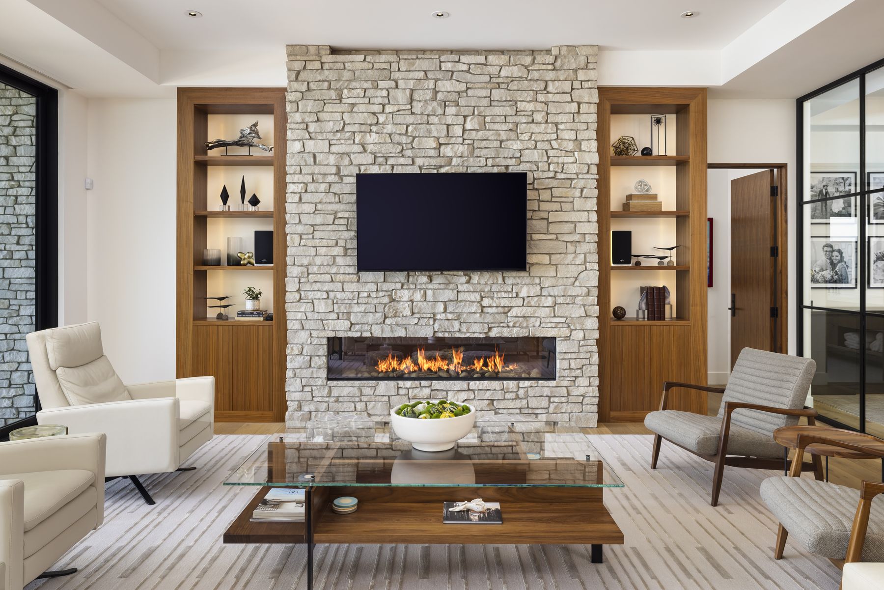 Floor-to-ceiling Silver Lake Ledge natural Michigan stone fireplace wall in a modern interior by Mike Schaap Builders