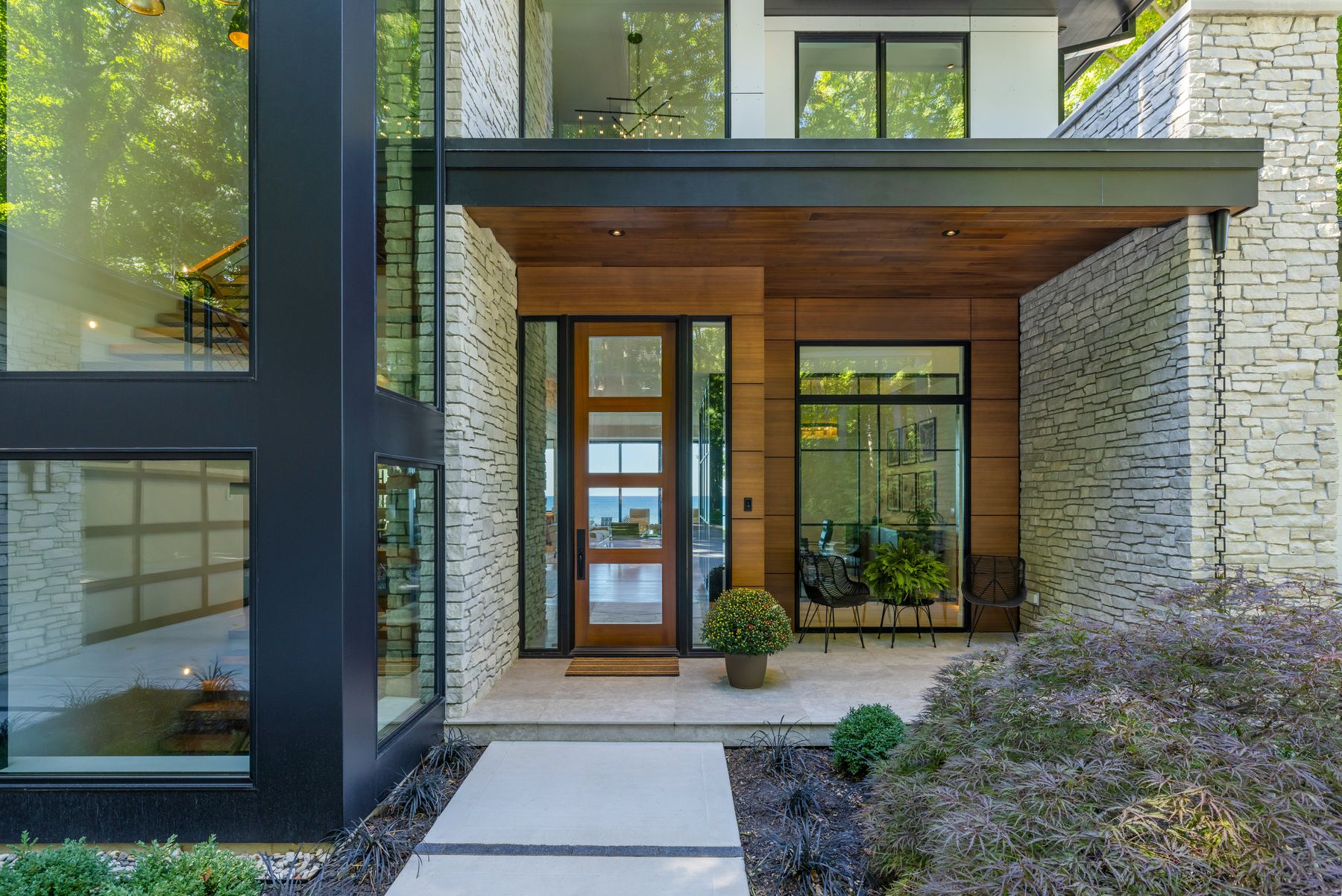 Silver Lake Ledge natural Michigan stone walls at a modern home entry by Mike Schaap Builders